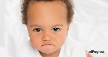 A toddler with an angry face