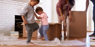 Two Toddlers Stomping on a Bubble Wrap