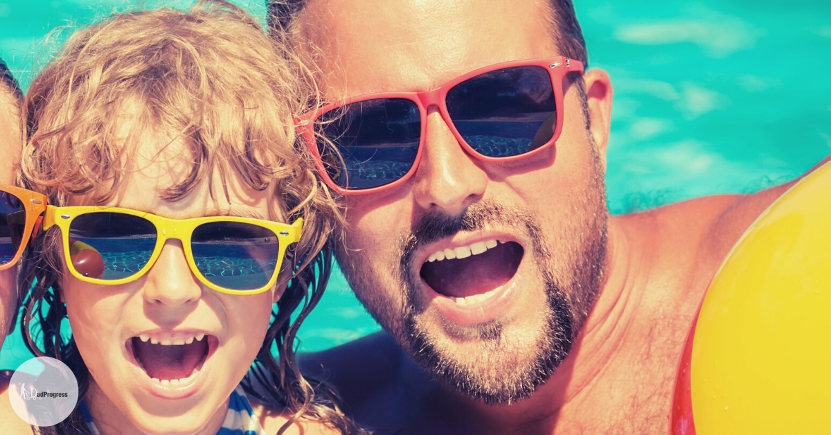 A father and a toddler wearing sunglasses in a pool
