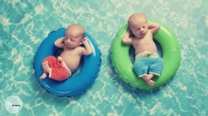 Two babies on swimming rings without life jackets