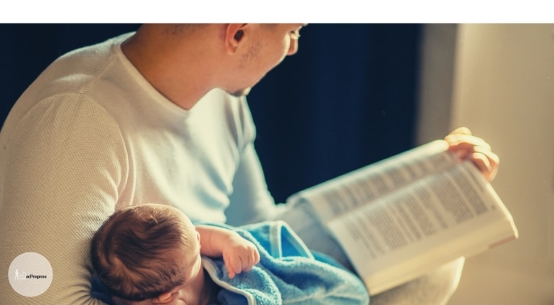 Dad Reading To A Baby From A Glider