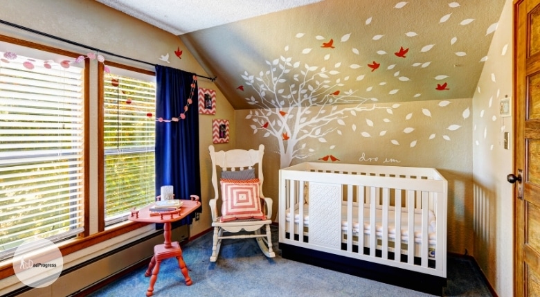 Nursery with a ceiling decorated with red birds and white leaves