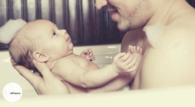 Picture showing a man holding a baby on a forearm